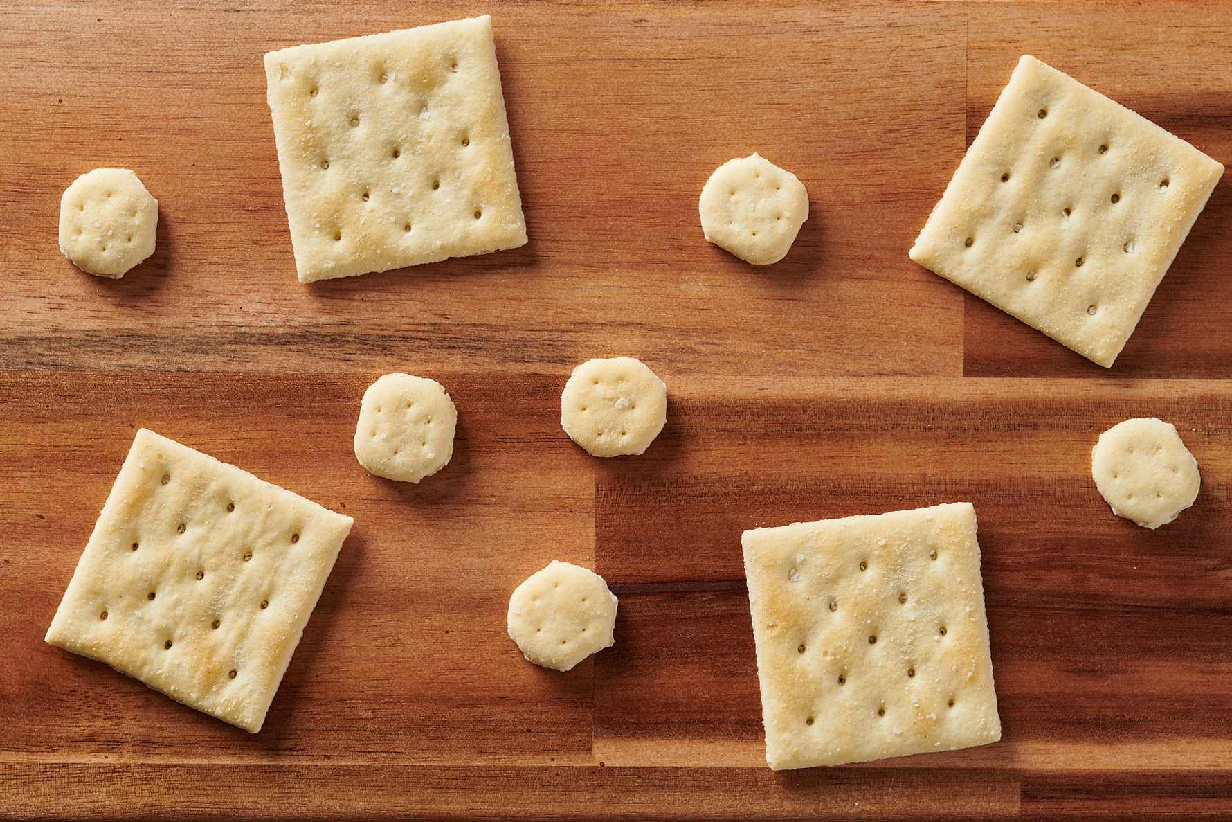 Assorted crackers on a wooden surface